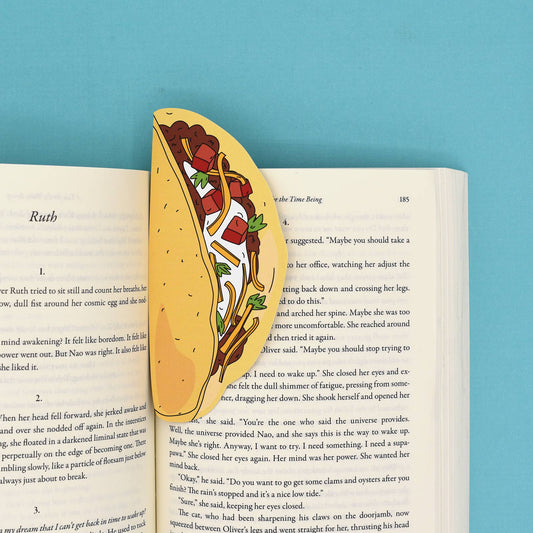 Bookmark shaped like a hardshell taco shown inside an open book.