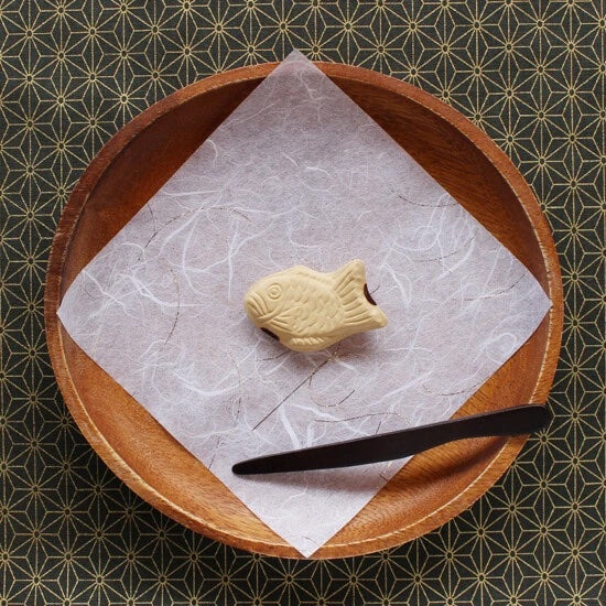 Taiyaki chopstick holder presented on a plate with fancy paper.