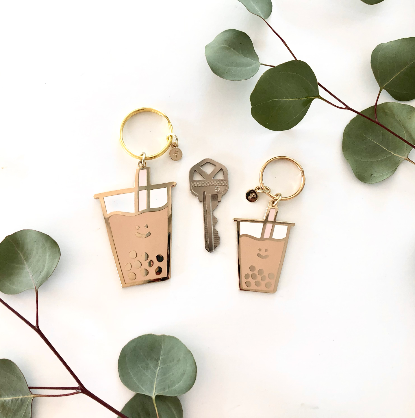 Large & Small - Photo of Boba Keychain with teal colored straw. Shown next to keychain for size.