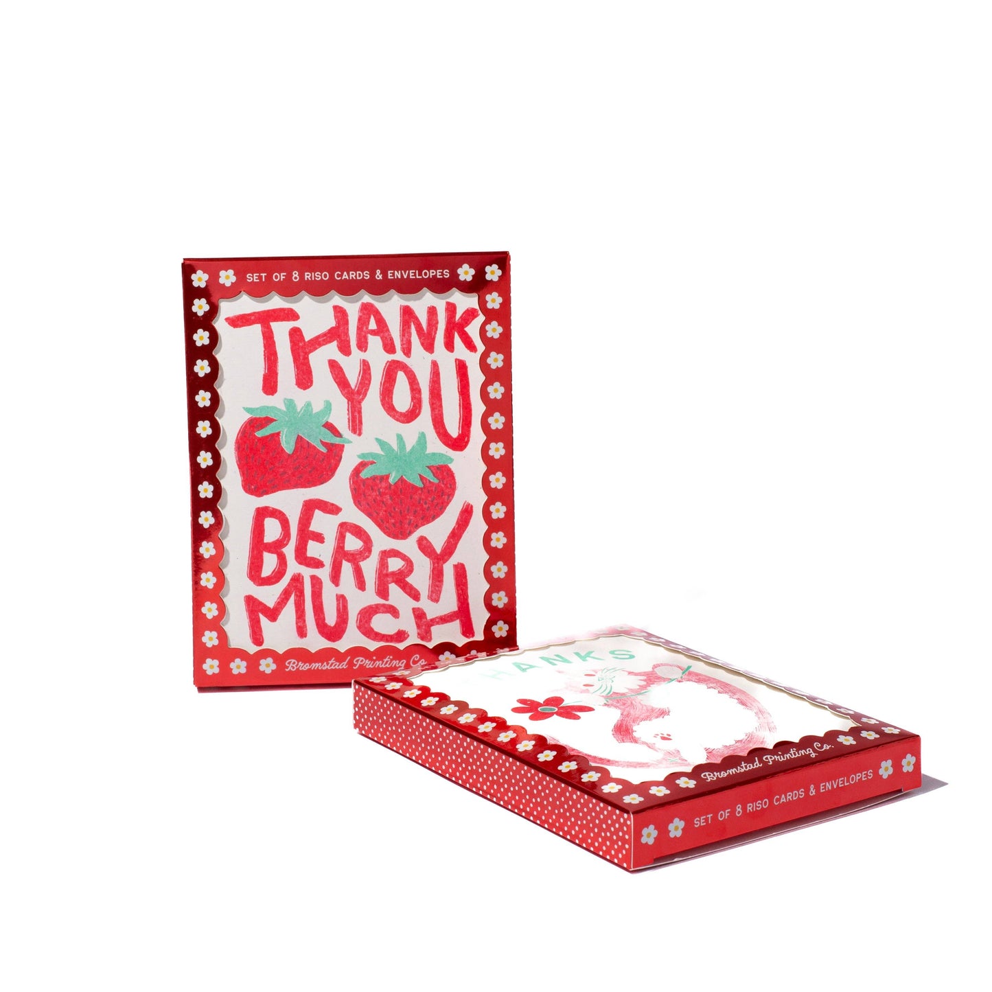 A boxed set of strawberry-themed thank you cards and envelopes on a clean white background. The packaging is red with white text reading 'THANK YOU BERRY MUCH' and illustrations of strawberries, with one card standing upright behind the box and another card partially visible inside the box.