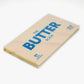Book titled 'The Butter Book' with blue text on a beige cover against a white background