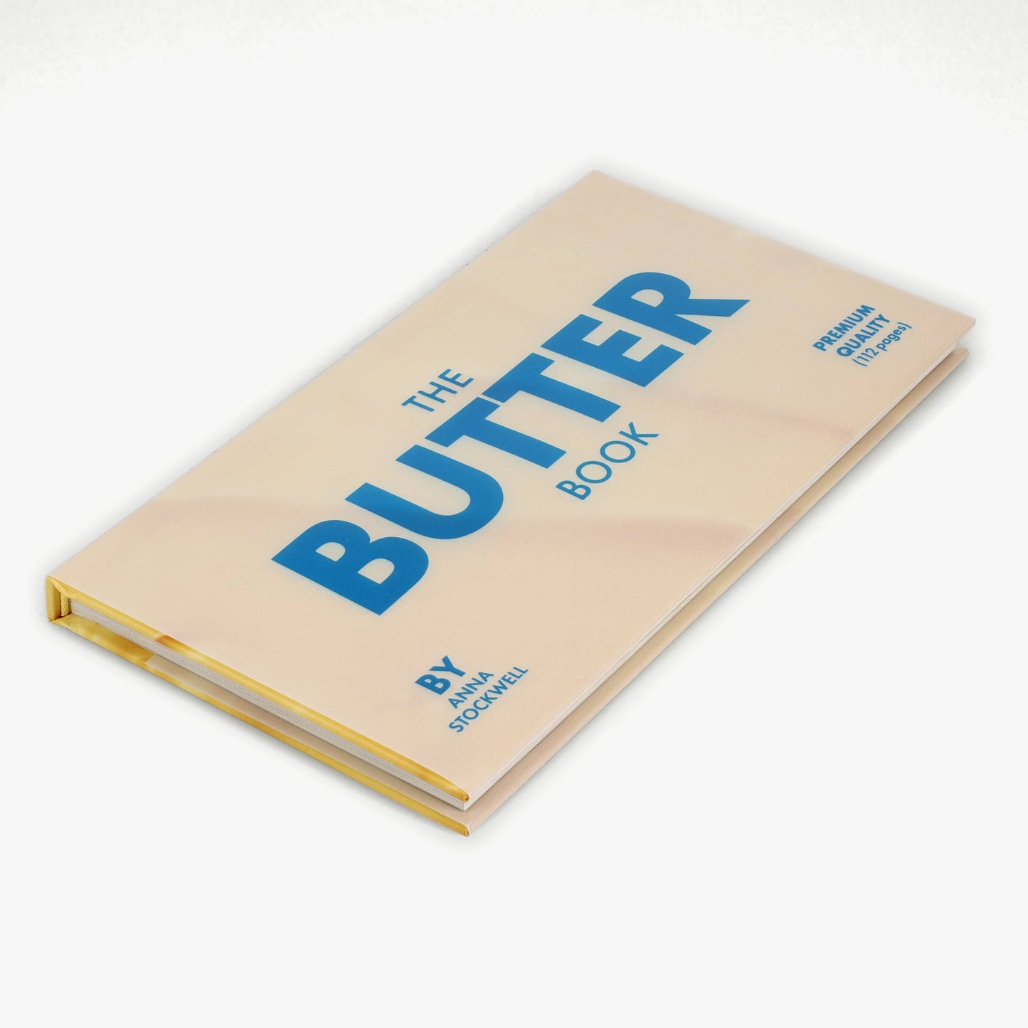 Book titled 'The Butter Book' with blue text on a beige cover against a white background