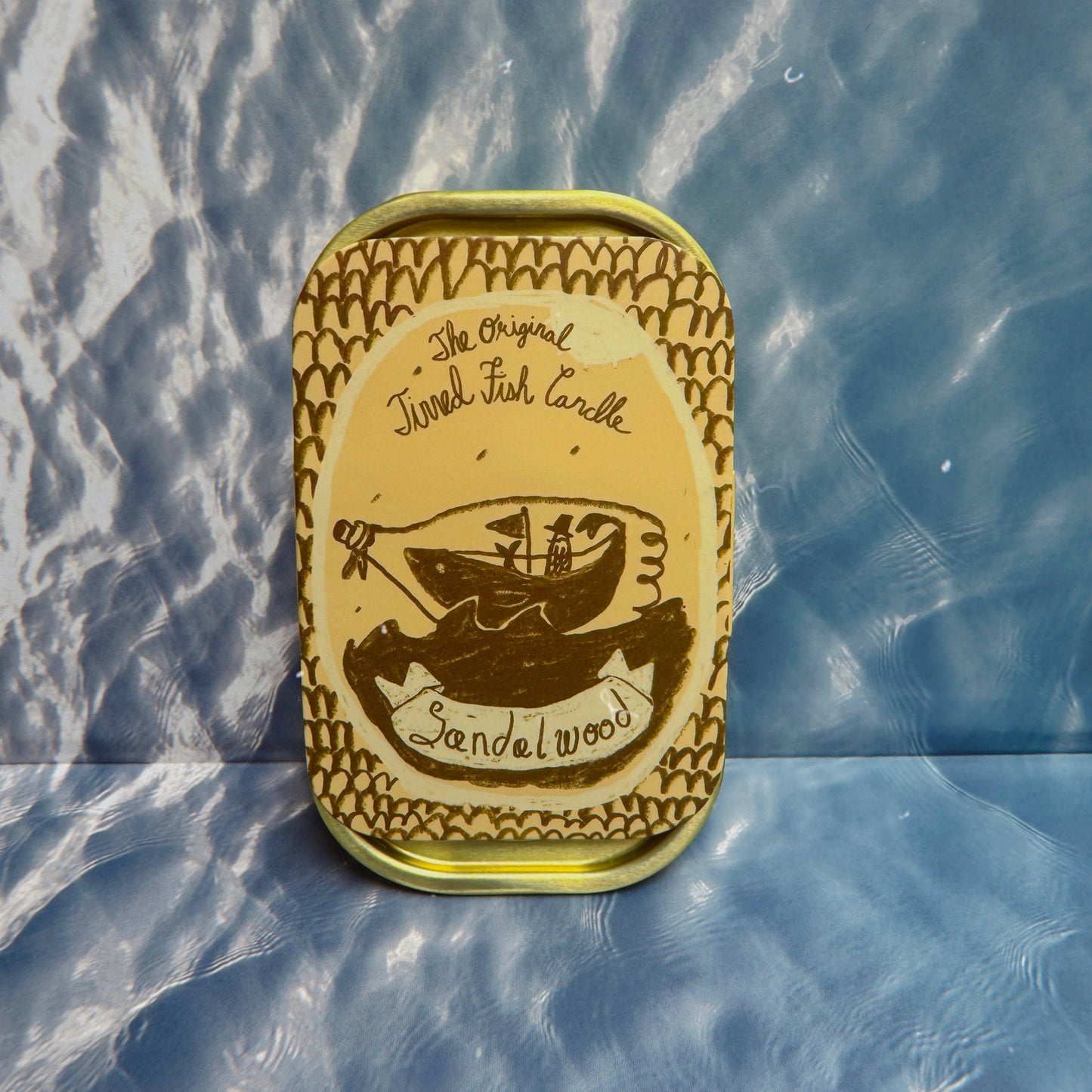 Tinned fish can with sandalwood scent on a textured blue surface