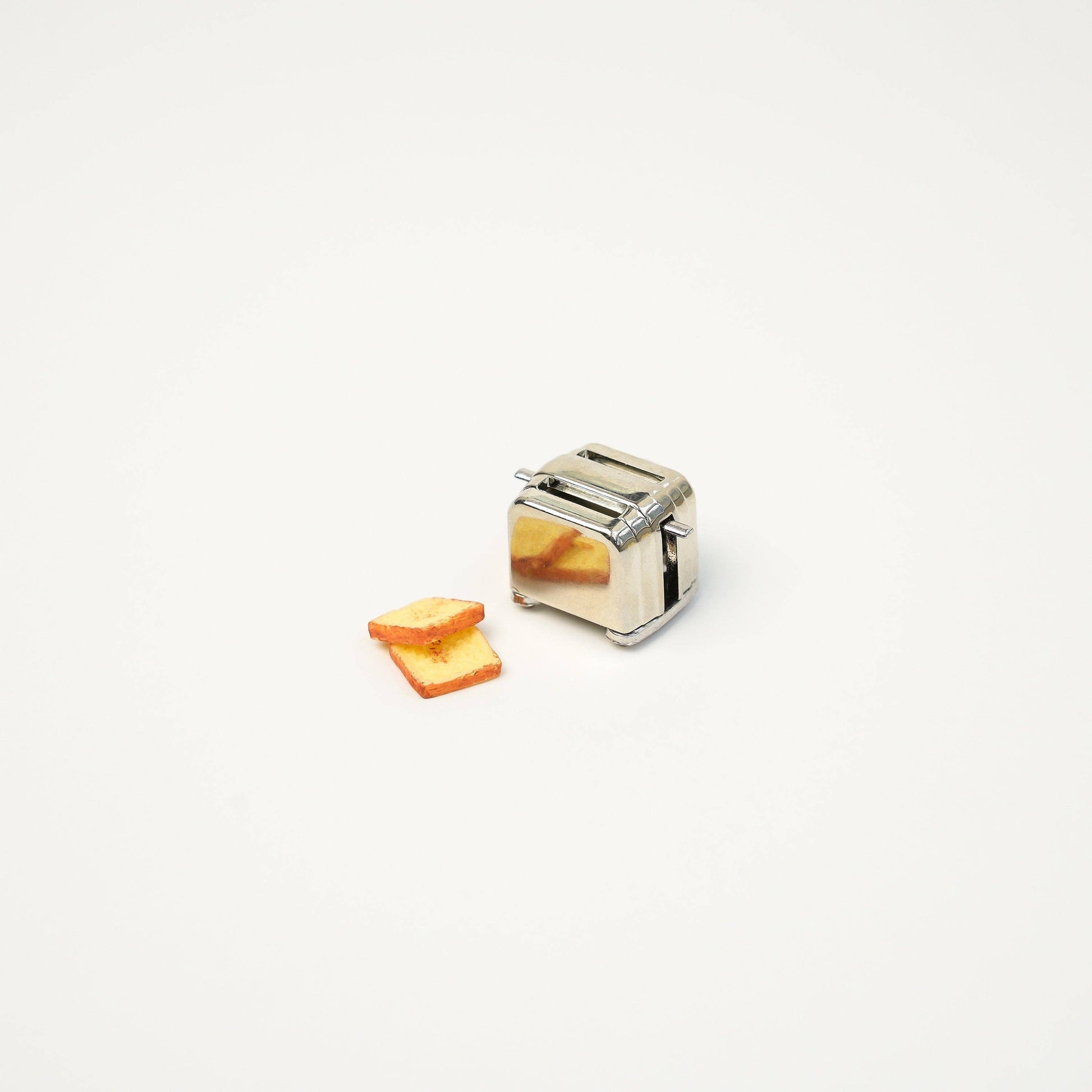 Mini toast sitting outside of the mini toaster magnet