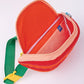 Fanny pack that looks like a tomato slice with seeds. Orange, red and yellow bag with green straps.
