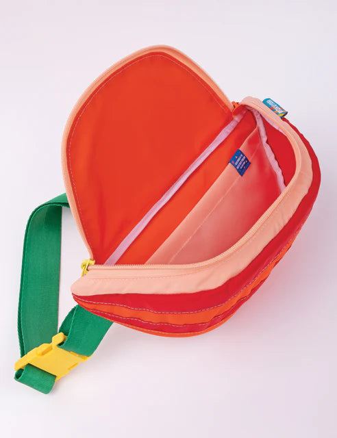 Fanny pack that looks like a tomato slice with seeds. Orange, red and yellow bag with green straps.