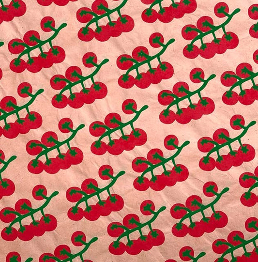 vibrant gift wrap sheet with light peach/pink background and vine tomatoes pattern on it