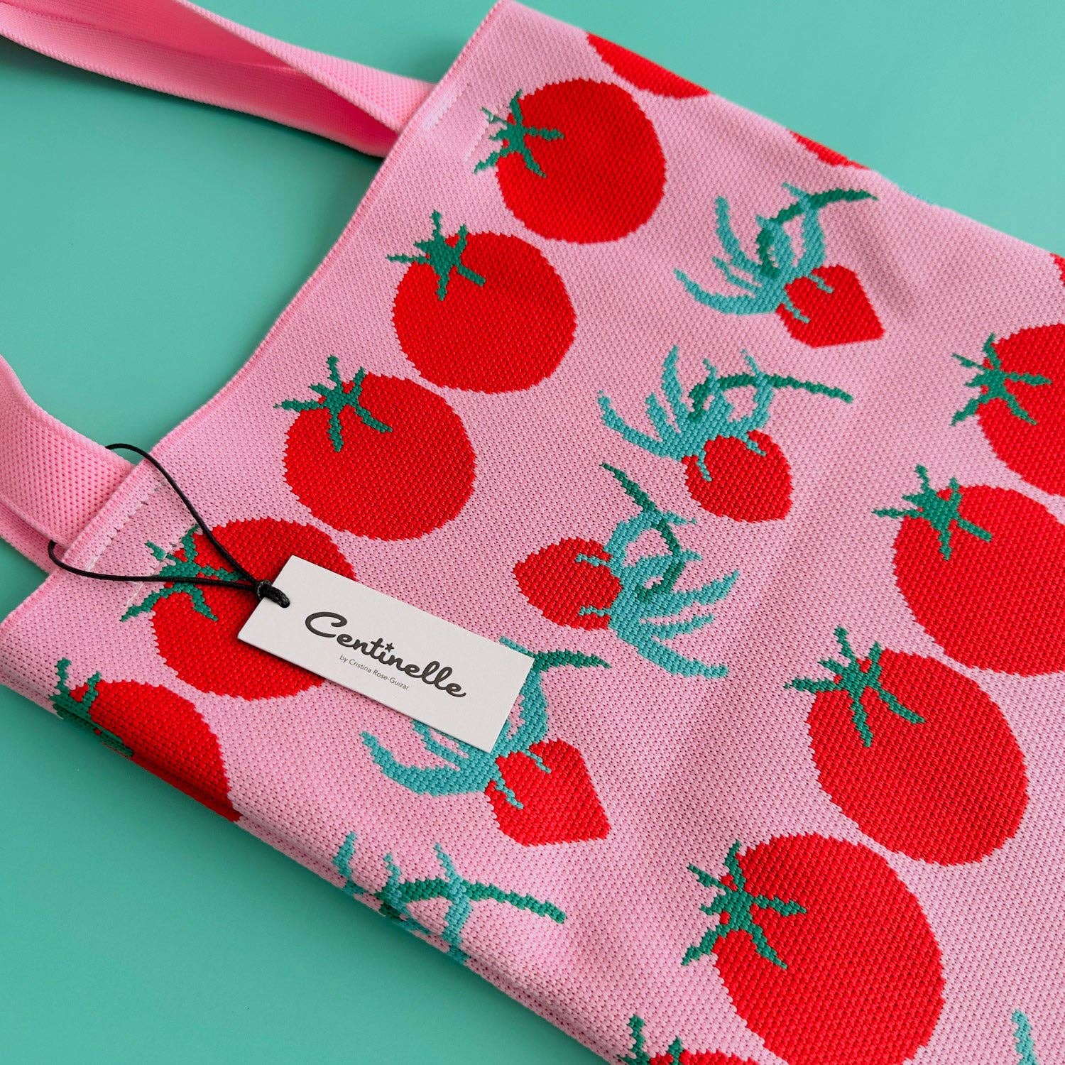 pink, knit tote bag with red tomatoes on it 