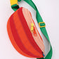 Bottom of the tomato fanny pack showing orange and red striped "skin" of the tomato.