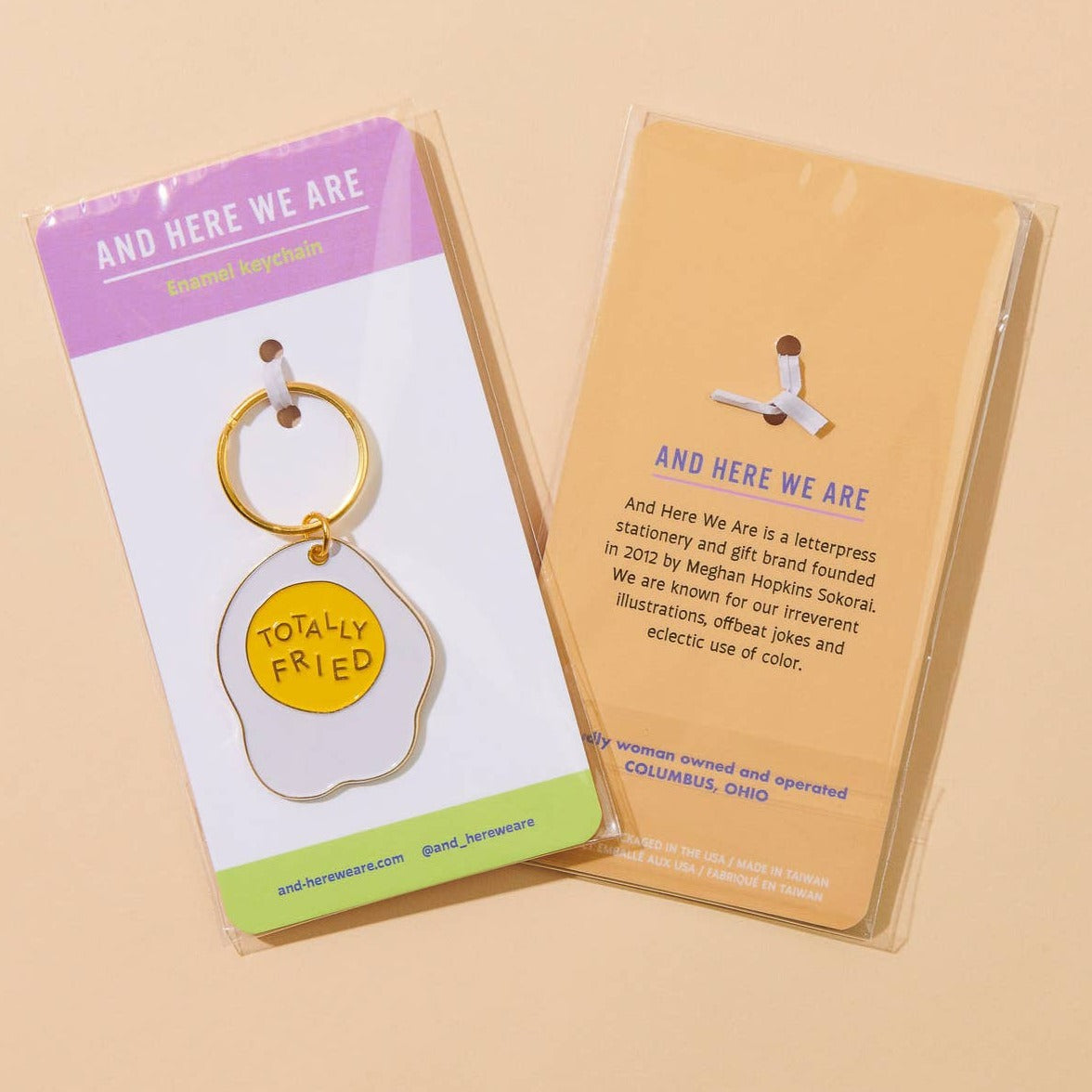 Enamel keychain of an egg that says Totally Fried.