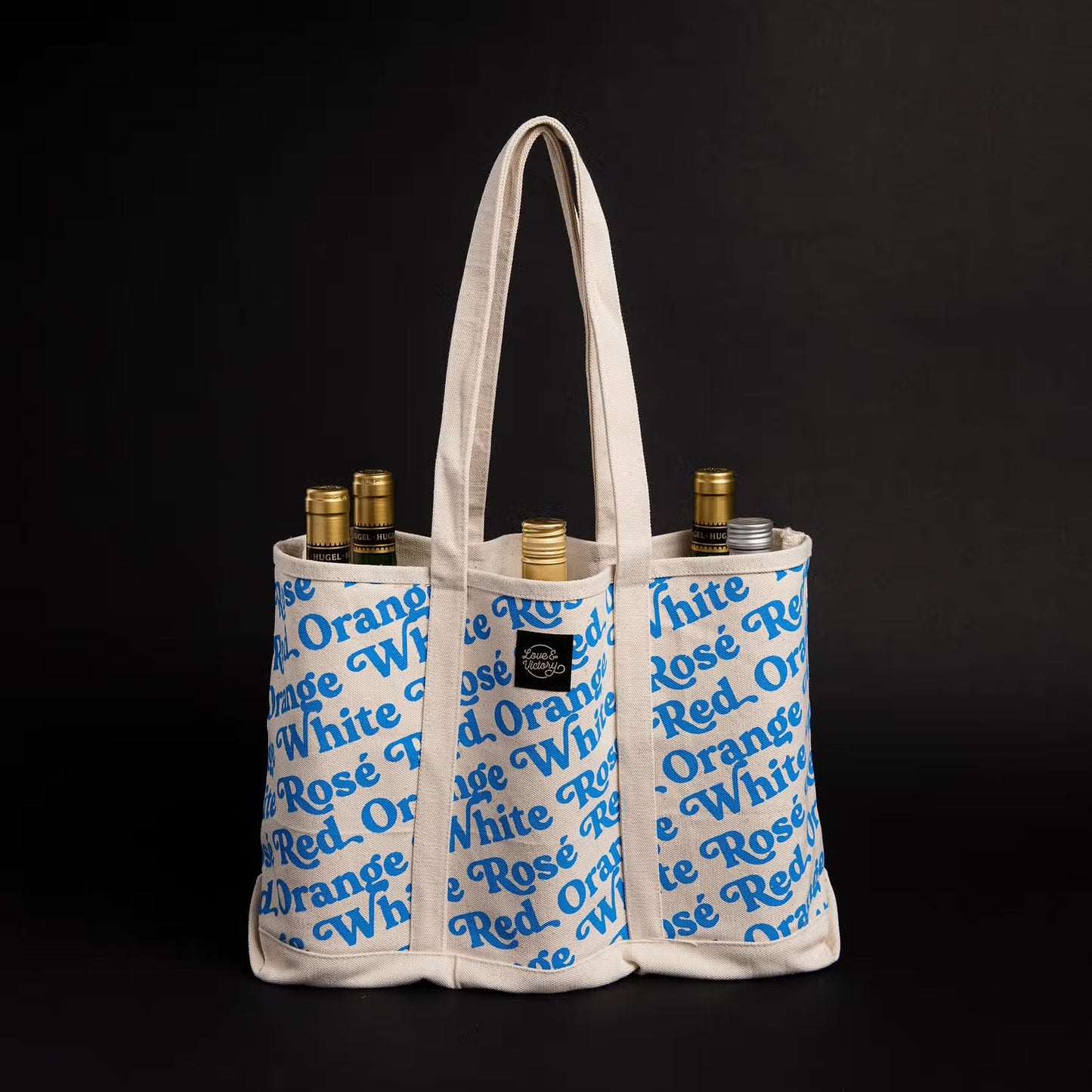 Wine Bottle tote bag with blue print. Repeat pattern that says White, red, rosé and orange.