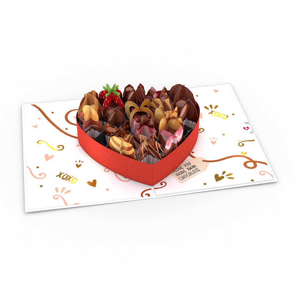 Panned out photo of the card that looks like a heart shaped box of chocolates. Design has XOXO and a fake tag.