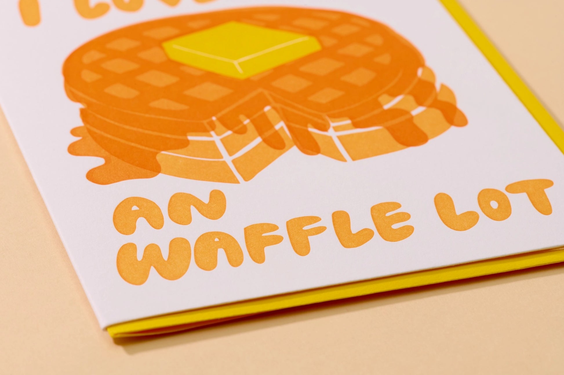 Close up of card that has waffles on it with syrup and butter. Yellow envelopes.