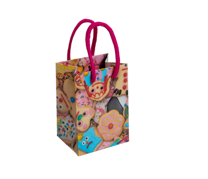 Small gift bag with colorful design and pink handles on a white background