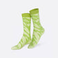 A pair of crew socks with a light green and pale yellow-green abstract wavy pattern, displayed on a clean white background.