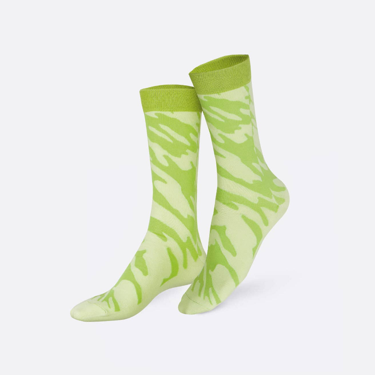A pair of crew socks with a light green and pale yellow-green abstract wavy pattern, displayed on a clean white background.