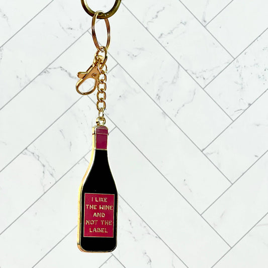 Keychain that looks like a wine bottle. Wine bottle label reads: I like the wine and not the label