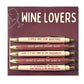 Set of pens with humorous wine-themed sayings on a maroon background with 'Wine Lovers' text.