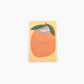 Notepad with peach design and 'NOTES' label on a white background