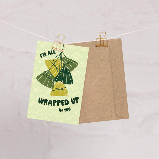Greeting card with several Zong Zi tied together with text that reads "I'm all wrapped up in you" 