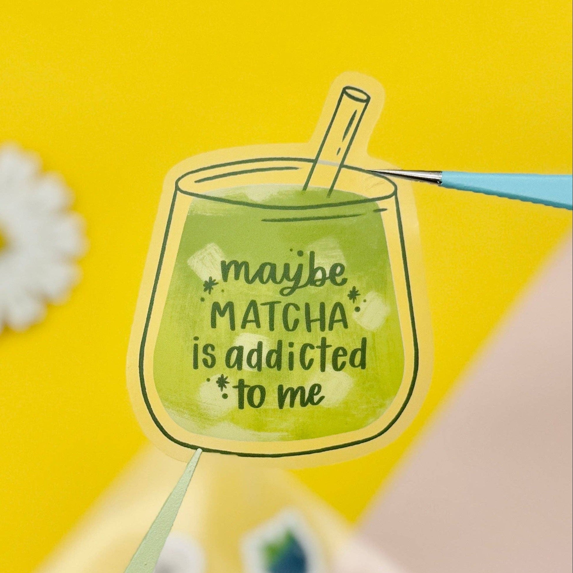 Illustration of a glass of matcha with text "maybe matcha is addicted to me" on a yellow background