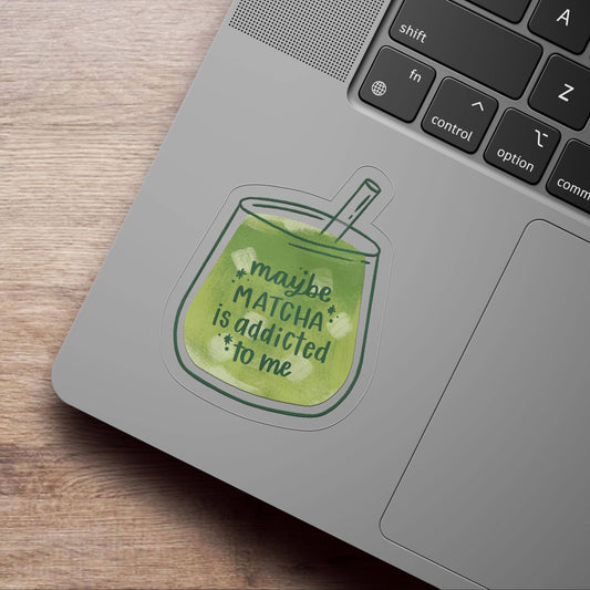 Laptop with a matcha green tea cup sticker on a wooden surface