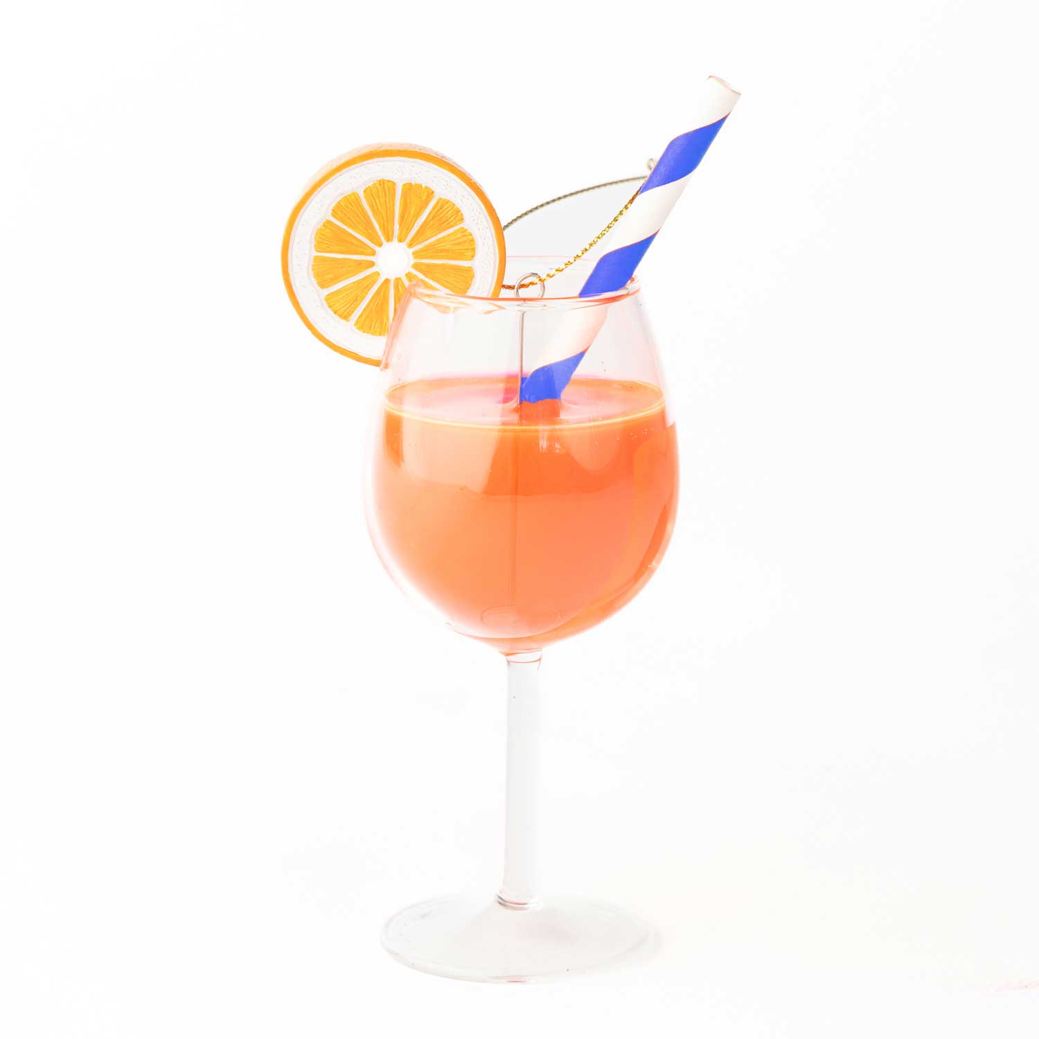 Aperitif in a stemmed glass with an orange slice and blue straw on a white background