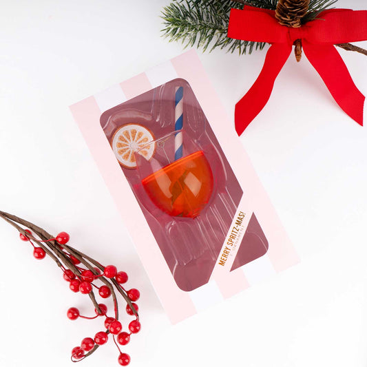 Red and white Christmas-themed product packaging with a red bow and festive elements on a white background.