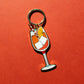 Keychain with an aperol spritz design on a red background