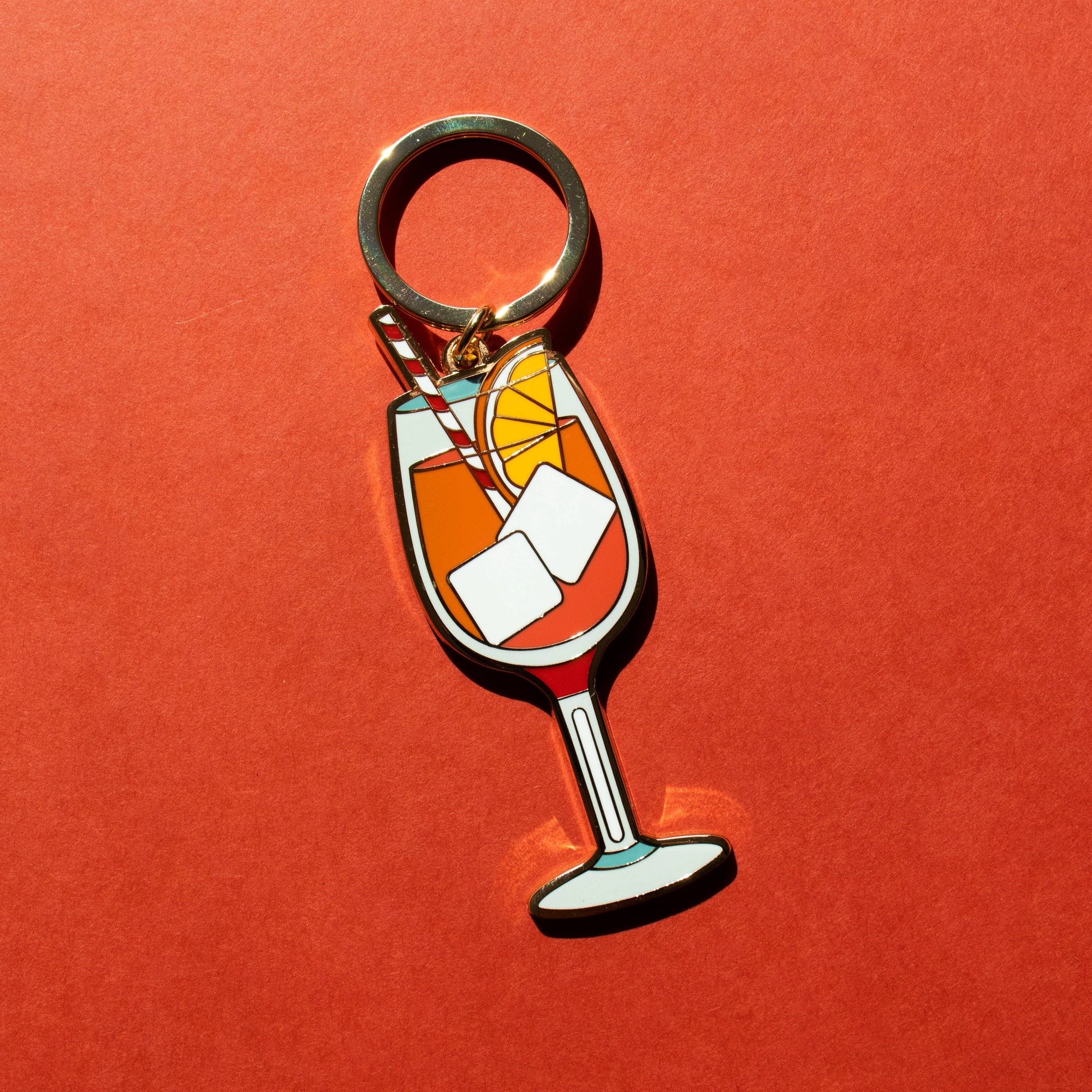 Keychain with an aperol spritz design on a red background