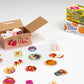 Cardboard box with colorful stickers of fruits and a box labeled 'Mister Citrus' on a white background.