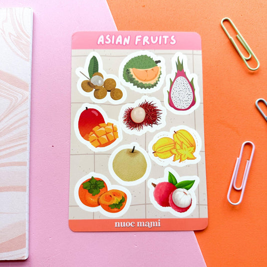 Sticker sheet with various Asian fruits on a pink card labeled 'Asian Fruits' against a colorful background.