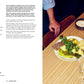 Cookbook page for "Cauli & Comte" with a dish of food on a table, accompanied by wine glasses and a glass of water.