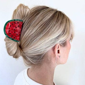 Watermelon hair claw shown in someone's hair 