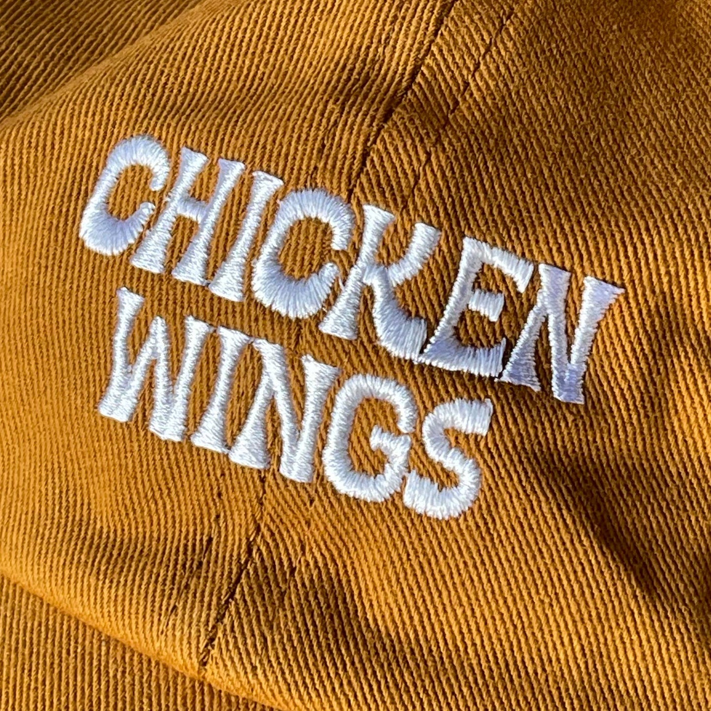 Close up of embroidered text that reads "chicken wings" 
