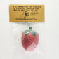 Back of package that reads: A strawberry de-stressor to squeeze through the rough patches of life.
