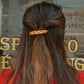 single baguette hair clip holding up hair 