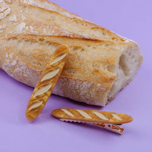 set of 2 baguette hair clips photographed against a real baguette 