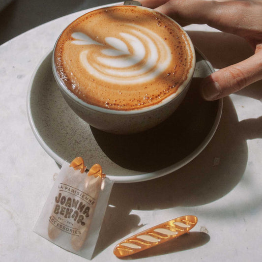 set of 2 baguette hair clips -- two packaged in bag with one loose. photographhed against a cup of coffee 