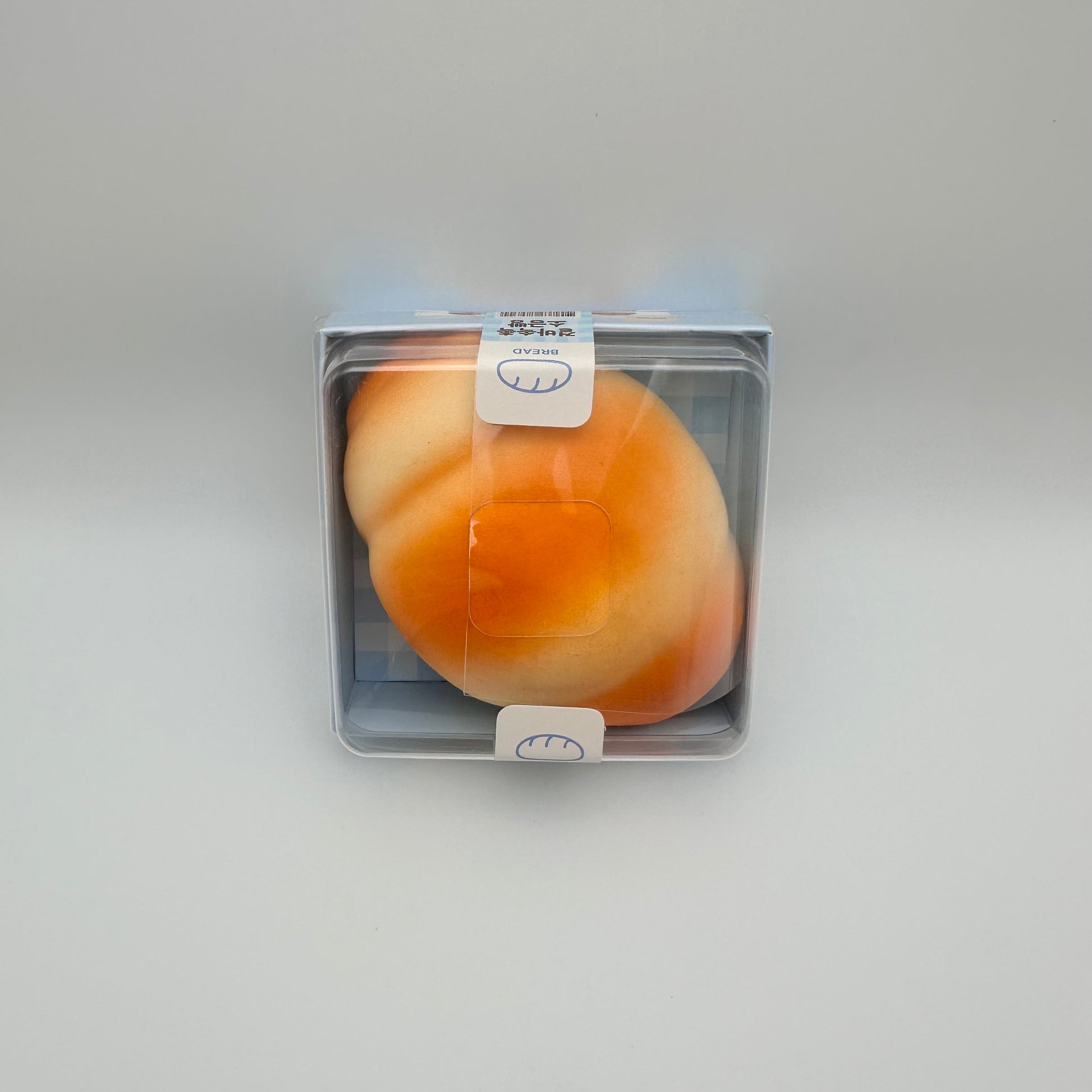 Stress ball that looks like a Japanese salt bread and comes in boxed packaging