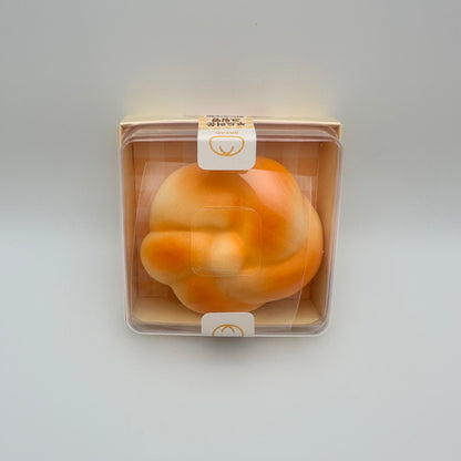 Stress ball that looks like a Cream Pan or Bread, pictured in it's box packaging