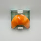 Packaged stress ball that looks like a croissant 