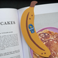 Banana-shaped bookmark on an open book about pancakes