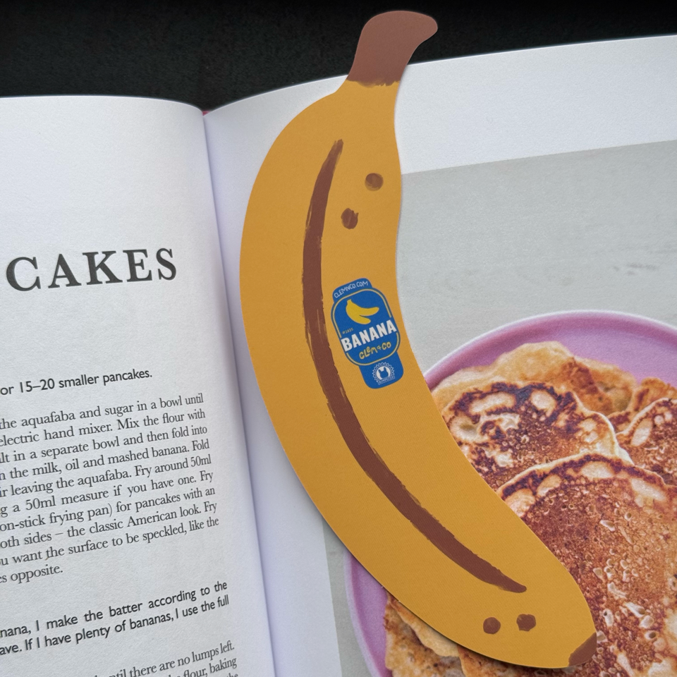 Banana-shaped bookmark on an open book about pancakes