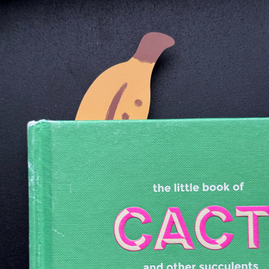 Green book with a banana bookmark peeking over the top.