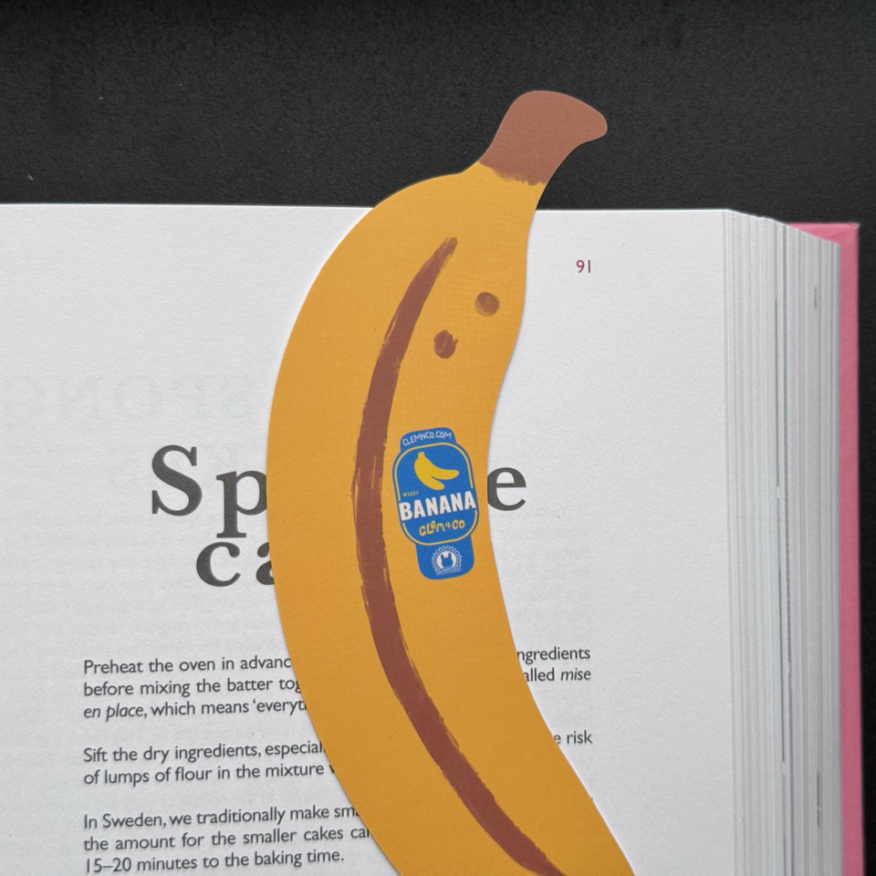 Banana bookmark with a label detail on an open book