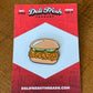 Chicken sandwich lapel pin with 3 pickles on a card backing that says Deli Fresh