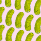 Pattern of green pickle magnets on a pink background