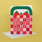 Greeting card with strawberry design and text 'To the berry best mom' on a yellow background