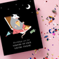 Card with an opposum illustration and text 'Birthdays are for staying up late eating trash' on a black background, with confetti on a pink surface.